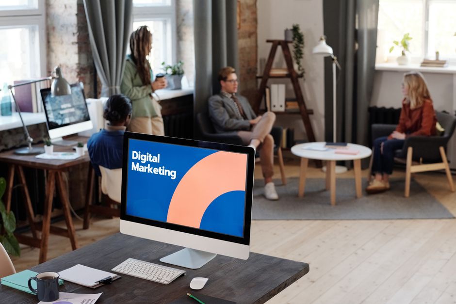 Collaborative team meeting in a modern office setting with digital marketing focus